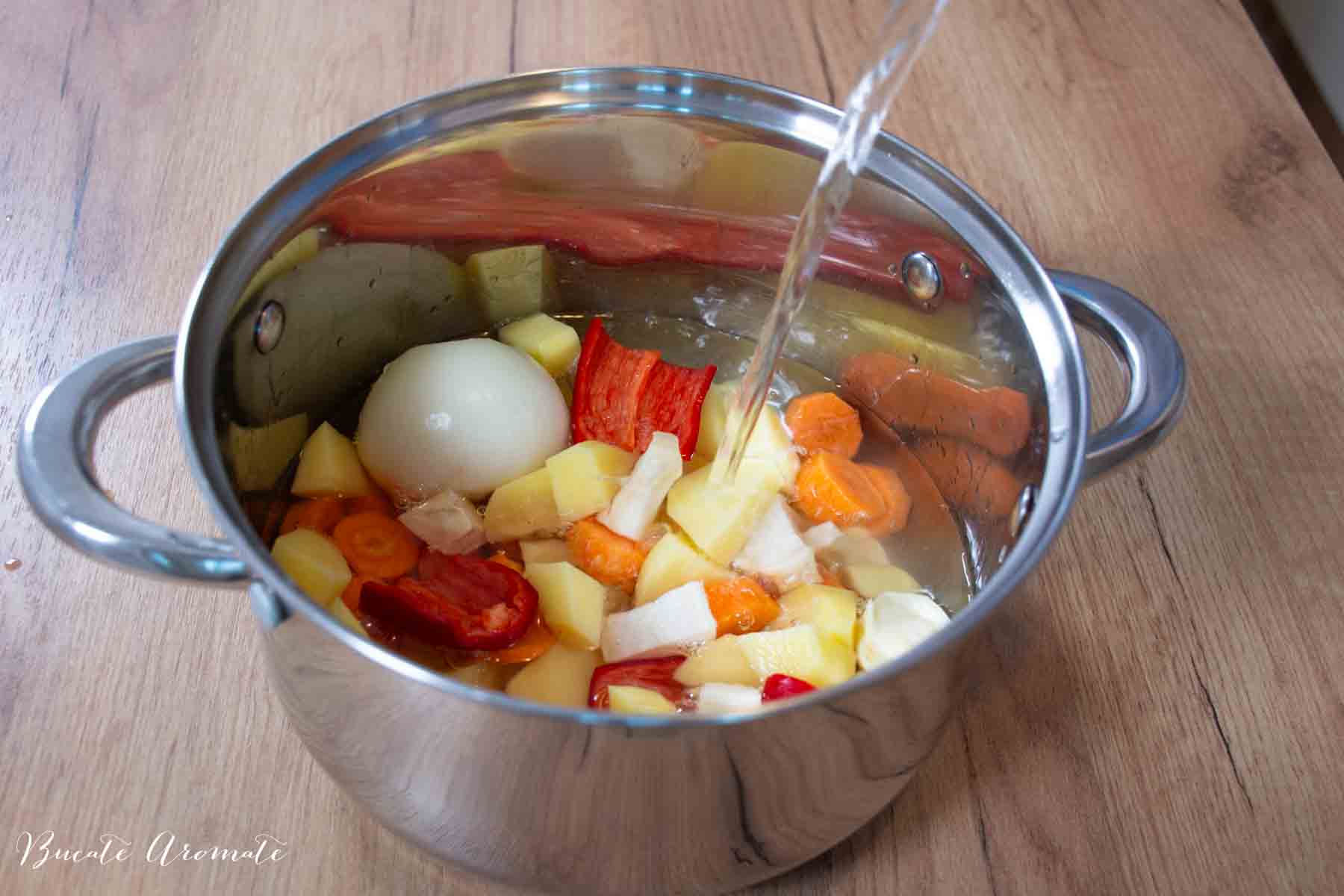 legume curățate și tăiate, puse în oală pentru supa