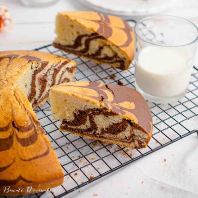 doua felii de chec pufos zebra cu cacao si un pahar cu lapte