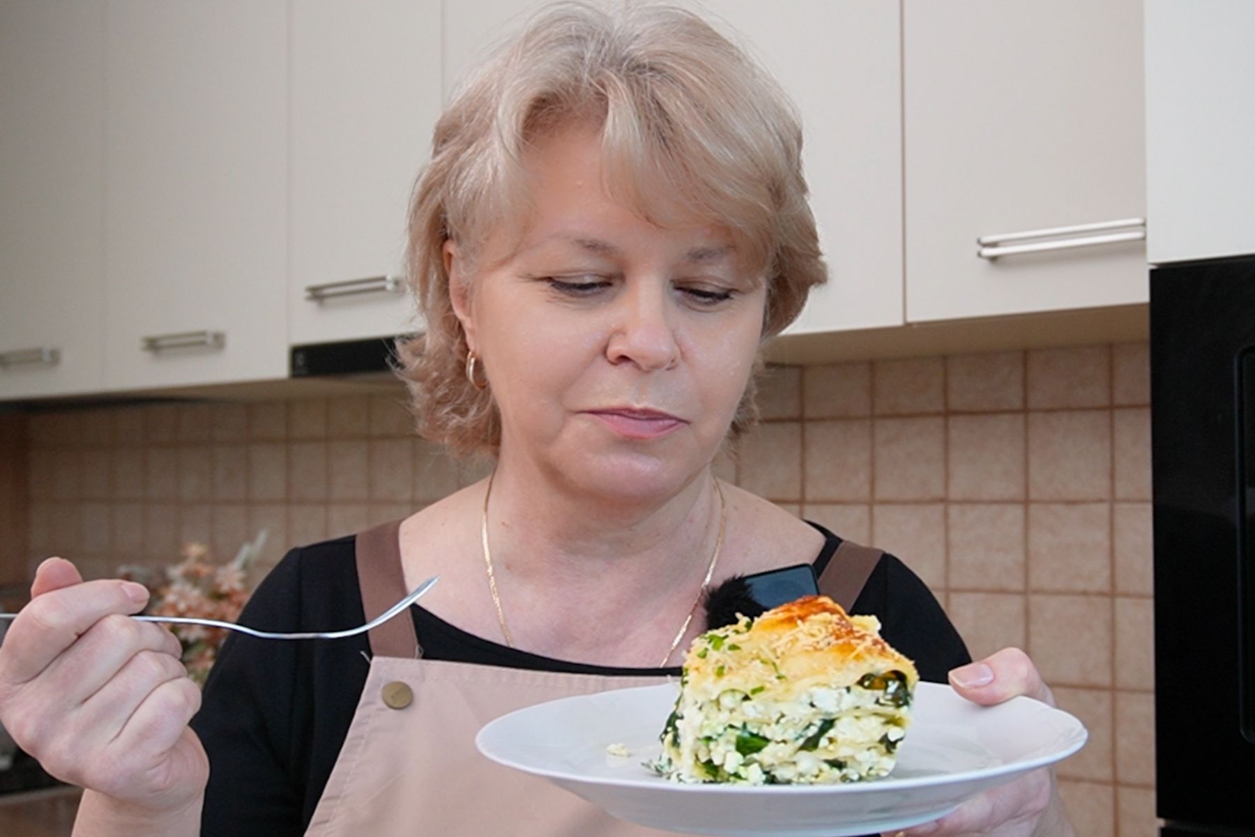 Iuliana Sbirnea prezentând o porție de lasagna cu ricotta și spanac, gătită acasă