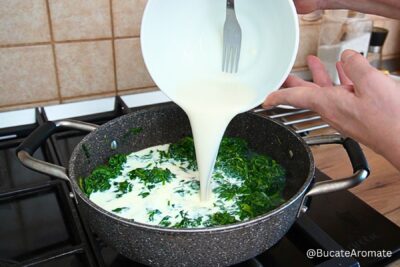 Amestecul de lapte și amidon turnat în tigaie peste spanacul sotat