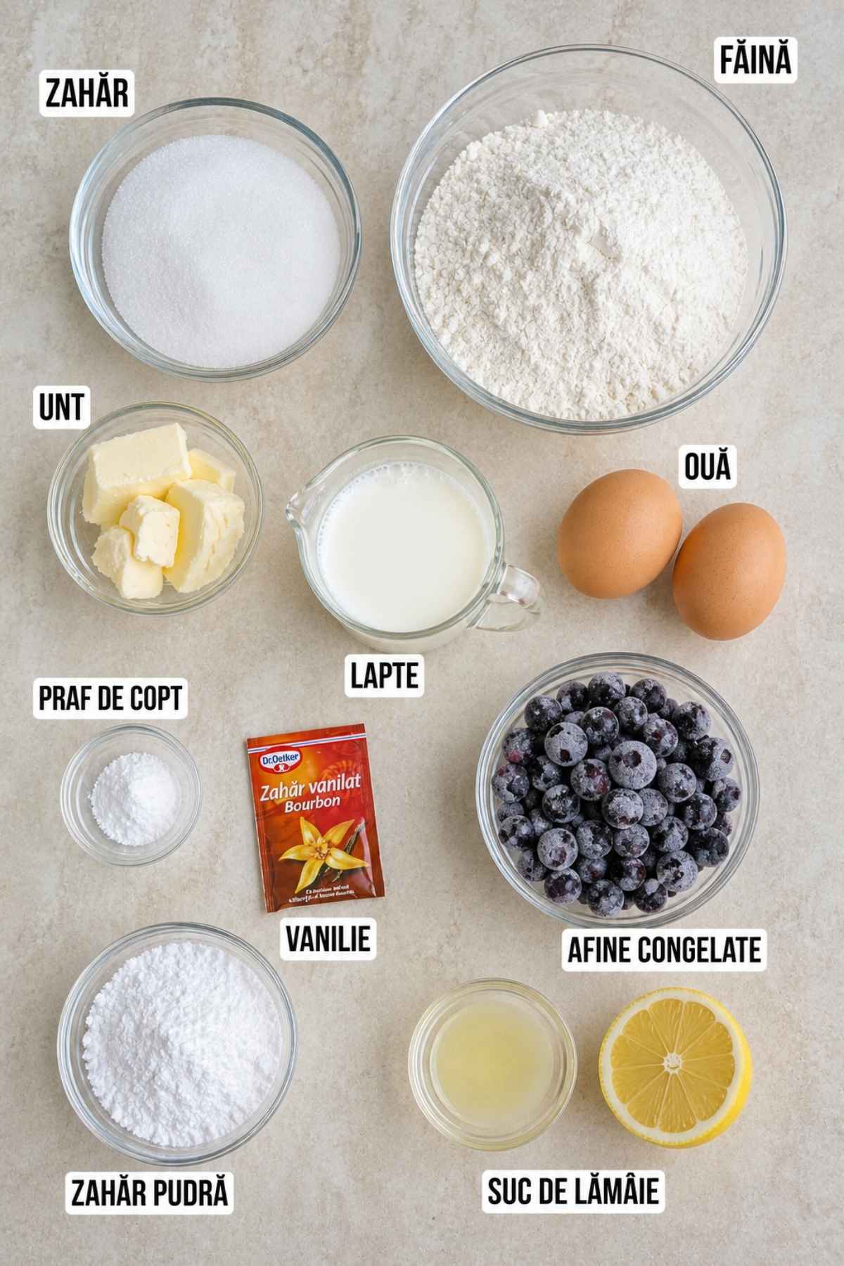 Ingrediente pentru brioșe cu afine și vanilie: făină, zahăr, unt, lapte, ouă, afine congelate, praf de copt, vanilie, zahăr pudră și lămâie.
