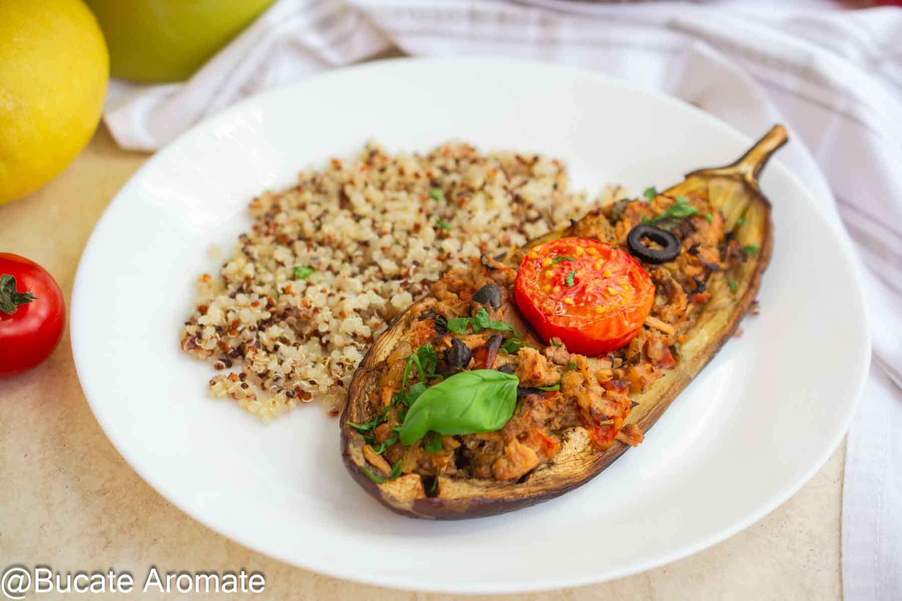 Vânătă umplută cu ton, roșii și măsline, servită cu garnitură de quinoa și busuioc proaspăt.