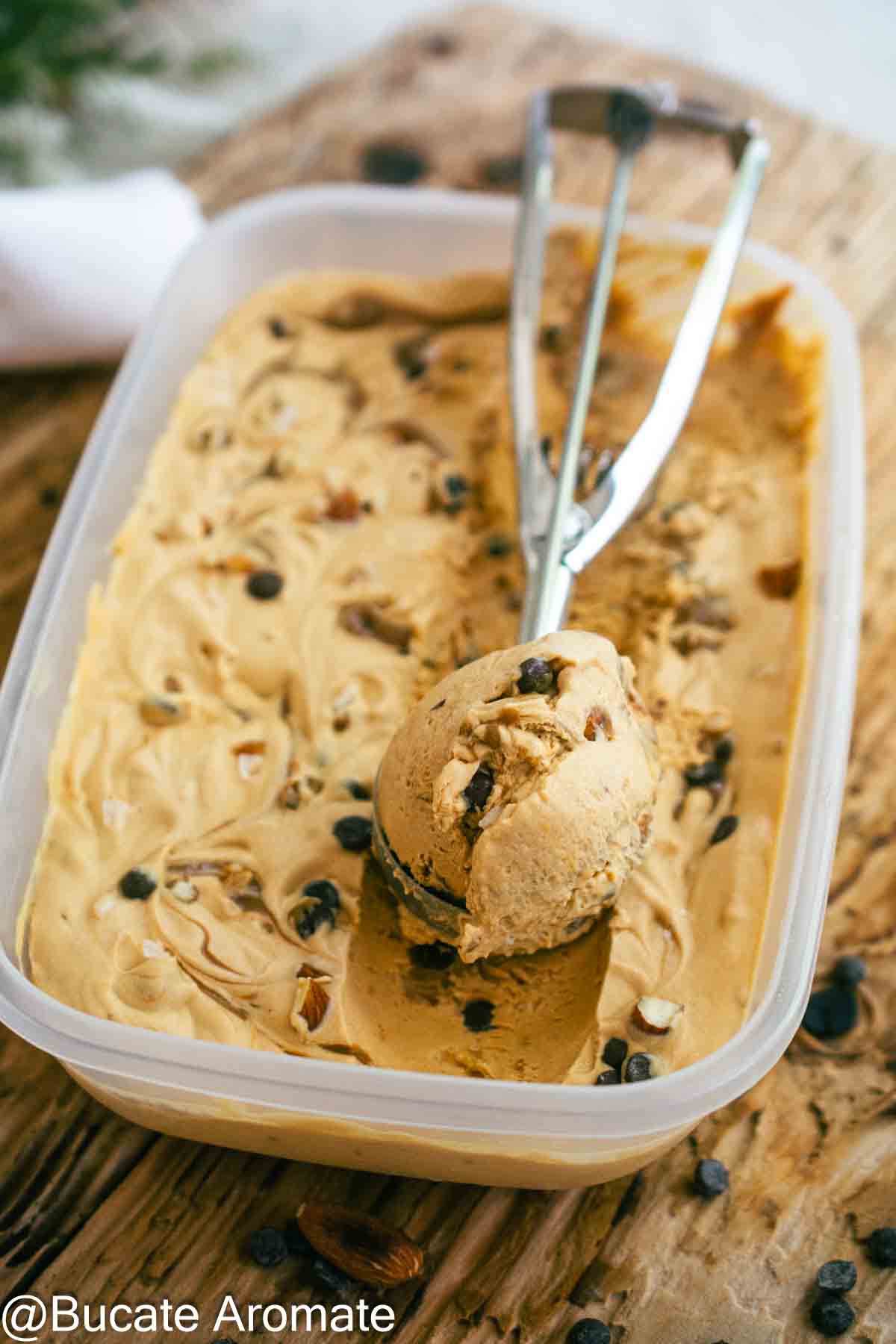 Înghețată cu dulce de leche și unt de arahide, scoasă cu cupa din caserolă, cu arahide și picături de ciocolată.